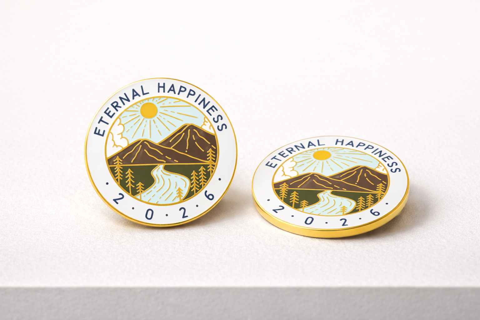 Two 'Eternal Happiness' pins with mountain and sun design on a white background