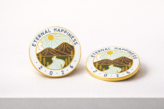 Two 'Eternal Happiness' pins with mountain and sun design on a white background